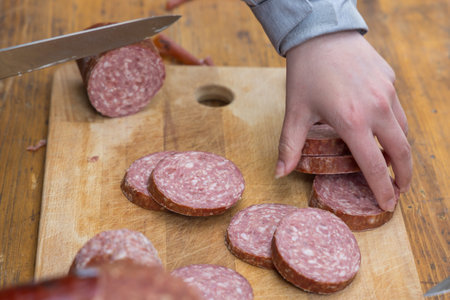 Sliced long-life salami in rollsの写真素材