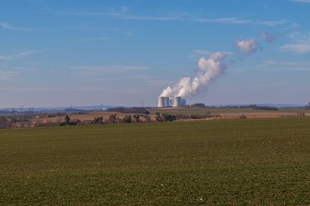 Dukovany Nuclear Power Plant in the Czech Republic, Europe. Smoke cooling towers. There are clouds in the sky. In the background the nature of the Highlands.の写真素材