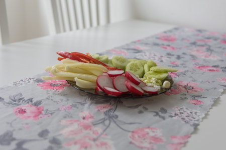 Healthy raw vegetables on a plate. Bell pepper, radish, cucumber, onionの写真素材