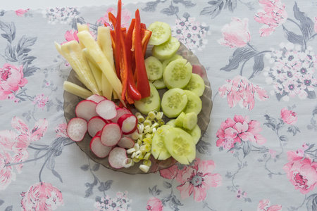 Healthy raw vegetables on a plate. Bell pepper, radish, cucumber, onionの写真素材