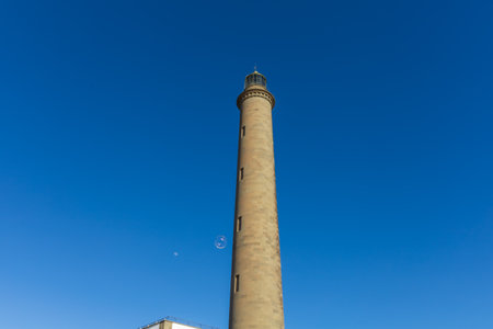 Faro de Maspalomas Spain seascape, beach and lighthouse Faro and sand dunes in Gran Canariaの写真素材