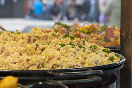 A detailed shot of a large pan or tray filled with traditional halusky or shaggy potato dumplings gnocchi. The dish has a light is with pieces of smoked meat or bacon.の写真素材
