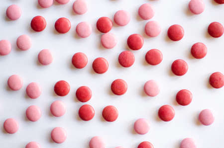 Background image of pink and red valentine chocolate laid on white backgroundの写真素材