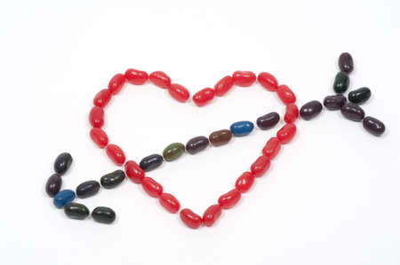 Jellybeans in the shape of a heart with arrow through it