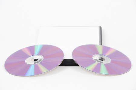Two purple DVD leaning on the bottom of a white case on a white backgroundの写真素材