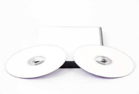 Two white DVD leaning on the bottom of a white case on a white backgroundの写真素材