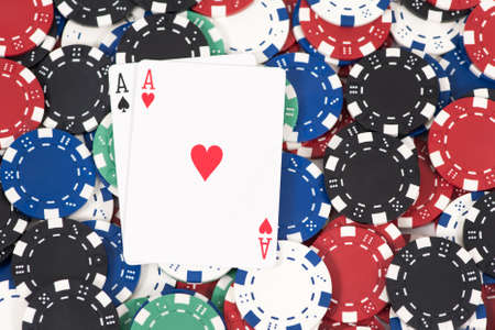 Two aces on a pile of poker chipsの写真素材