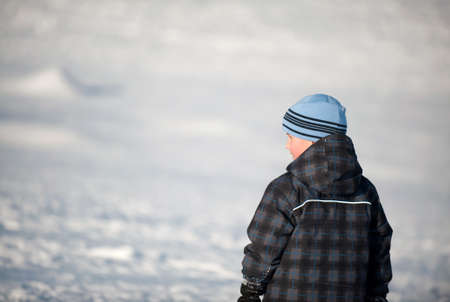 boy looking down the ski hill