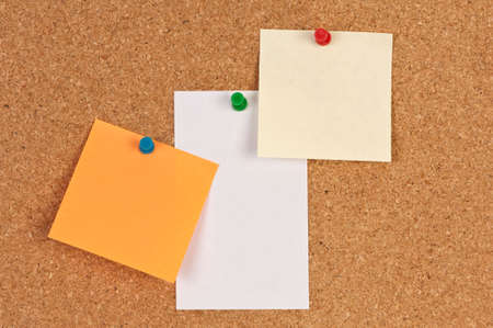 Three pieces of paper on a corkboardの写真素材