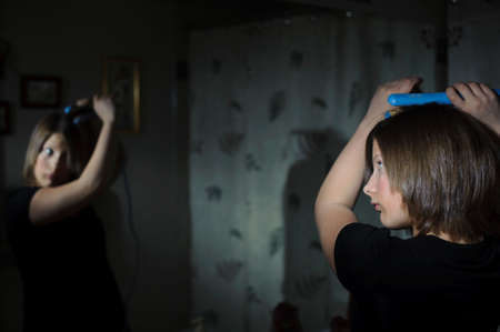 A teenage girl getting ready in the bathroomの写真素材