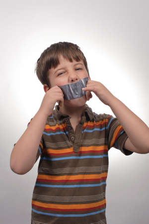 Tape on a loud little boy mouthの写真素材