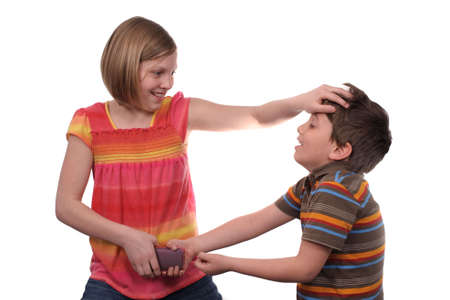 Two young kids fighting over a cell phone