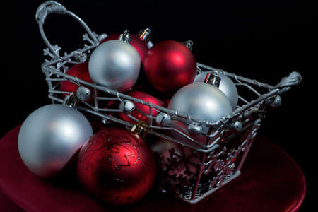 Red and silver christmas balls in a basketの写真素材
