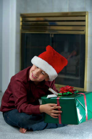 A boy trying to figure out what is in the gift boxの写真素材