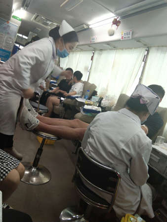 Workers are seen working in a room.の写真素材