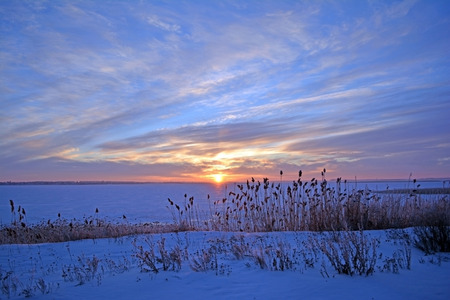 Landscape photo of sunset on a frozen lake in winterの写真素材