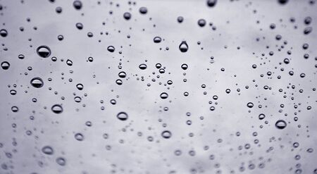 Raindrops on the glass surface. Texture of a drops of water.