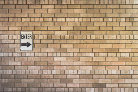 old brick wall background with enter signの写真素材