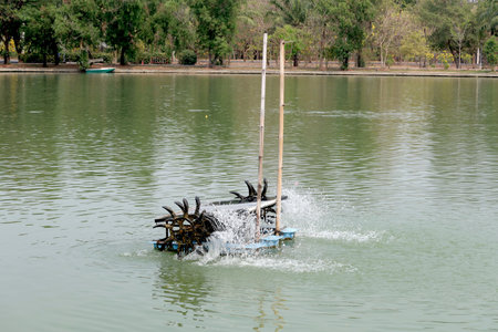 Water turbine in the dirty pond at the public park,Bangkok,Thailand,Asiaの写真素材