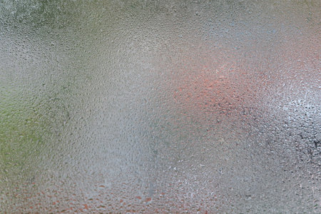 Glass with water vapor, fog, flow. a window with water drops. fogged glassの写真素材