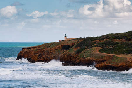 Seascape at the ruins roman of tipasa with Rough sea. Lighthouse on the coastの写真素材