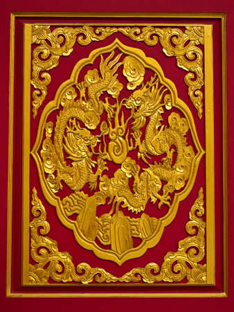 gold chinese dragon on red backgroundの写真素材
