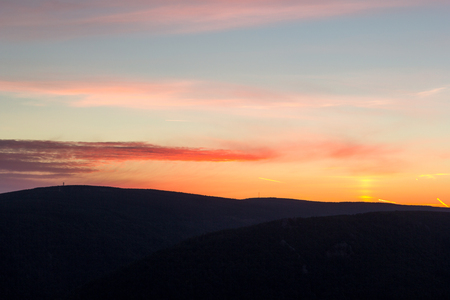 Beautiful calm sunrise over forest in mountains, near Frydlantske Cimburi rock formation, Hejnice, Czech Republicの写真素材