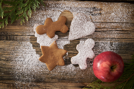 Christmas homemade gingerbread cookies and Christmas tree on a wooden backgroundの写真素材