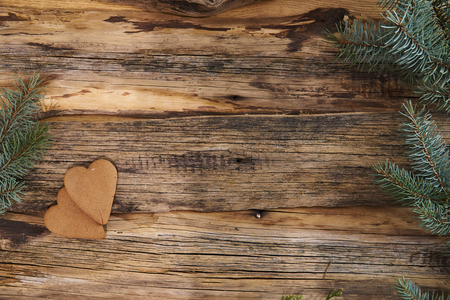 Christmas homemade gingerbread cookies and xmas tree on a wooden backgroundの写真素材
