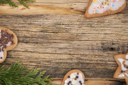 Christmas homemade gingerbread cookies and xmas tree on a wooden backgroundの写真素材