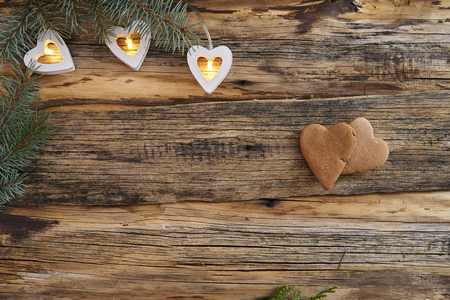 Christmas lights among spruce needles flat spread on an old, wooden background with copy space.の写真素材