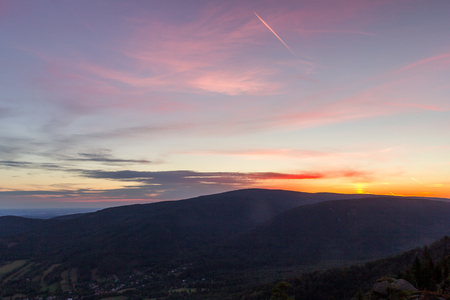 Beautiful calm sunrise over forest in mountains, near Frydlantske Cimburi rock formation, Hejnice, Czech Republicの写真素材