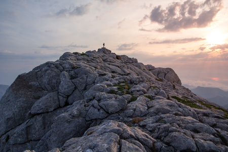 Young and beautiful teenage woman with backpack hiking in mountains. Serra de Tramuntana, Mallorca, Spainの写真素材