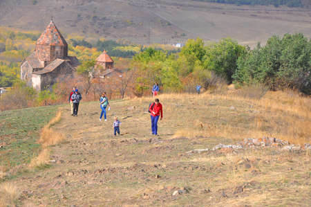 SEVANAVANK, ARMENIA - OCTOBER 14, 2016: People walk along the ridge from the monastery. The monastery was founded in 874. This is a very popular sightseeing objectのeditorial素材