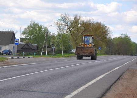 ZVENCHATKA, BELARUS - MAY 12, 2017: Tractor rides on an asphalt rural road