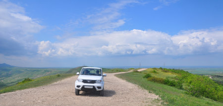 MOUNTAIN KOKLYUK, RUSSIA - MAY 13,2019: Russian SUV UAZ Patriot on a dirt road in Crimeaのeditorial素材