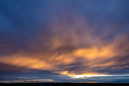 Bright sunset with colorful clouds over the horizon in the eveningの写真素材