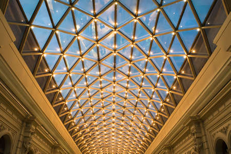 Glass roof with lights and blue sky background