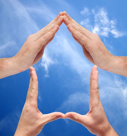 Conceprtual home symbol on sky backgroundの写真素材