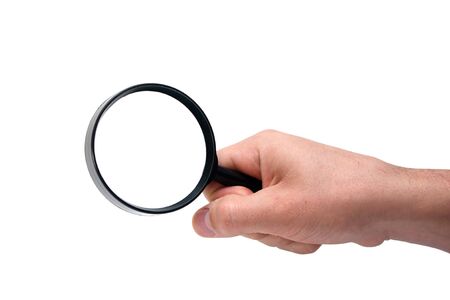 Hand holding magnifying glass isolated on white backgroundの写真素材