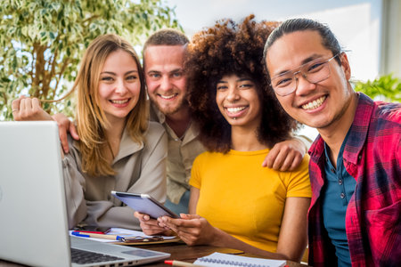 happy multiethnic group of Young people employees workers with laptop in startup studio.Human...