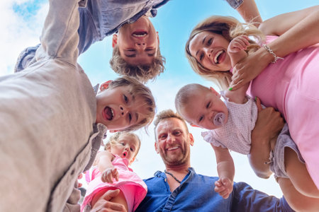 shot from below of a family having fun outdoors.
