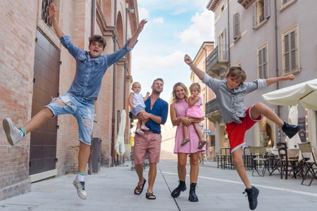 young family having fun outdoors while walking in the city.の写真素材