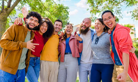 portrait of multiethnic group of friends posing in the street outdoors laughing and having fun. diverse people celebrating life together enjoying happy holidays. lifestyle, travel and joy conceptの写真素材