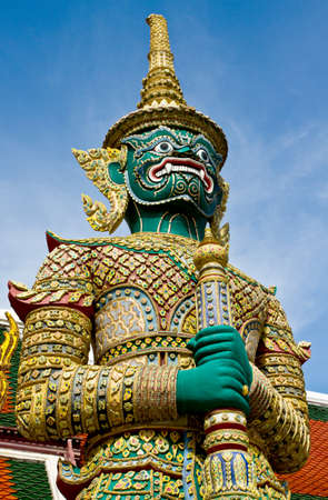 Giant standing in front of a buddhist temple, Bangkok, Thailand の写真素材