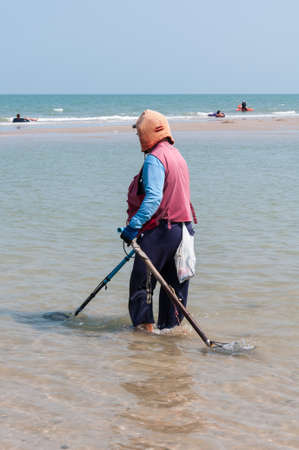 People find valuables on the beach.の写真素材