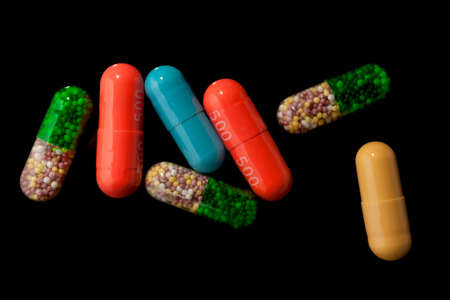 Colorful pills over dark background