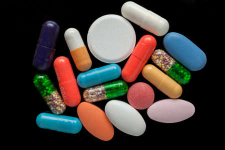 Colorful pills over dark backgroundの写真素材