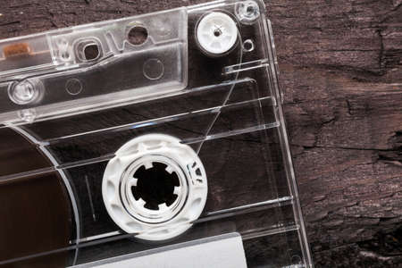 Vintage Compact Cassette on black wooden background
