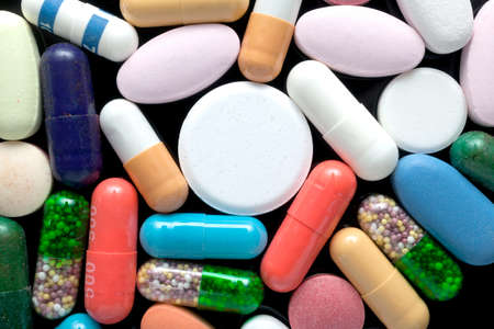 Colorful pills over dark background